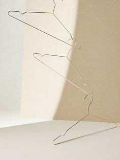 a wire sculpture sitting on top of a white table next to a paper towel holder