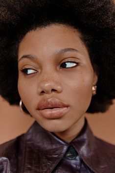 a close up of a person with an afro