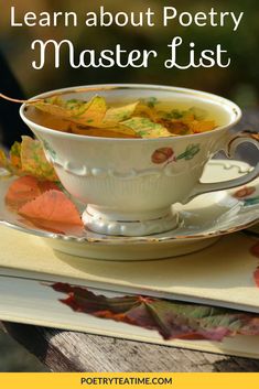 a white cup filled with soup sitting on top of a table next to an open book