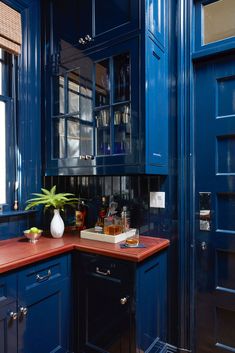 a kitchen with blue cabinets and red counter tops