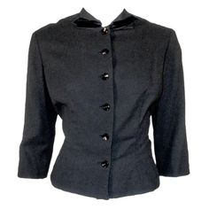 For Sale on 1stDibs - This is a charming vintage fitted jacket from designer Howard Greer. it is made of a light weight black wool, with black velvet trim on the collar and Chic Fitted Tweed Jacket For Formal Occasions, Fitted Elegant Tweed Jacket With Buttons, Fitted Black Tweed Jacket With Suit Collar, Formal Fitted Black Tweed Jacket, Black Fitted Tweed Jacket For Formal Occasions, Fitted Black Tweed Jacket For Tailoring, Classic Evening Tweed Jacket For Winter, Vintage Fitted Outerwear With Padded Collar, Classic Fitted Blazer With Padded Collar