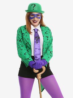 a woman dressed up in a costume and holding a cane with question mark on it