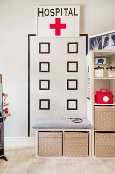 a hospital room with boxes and drawers in front of the medical sign on the wall