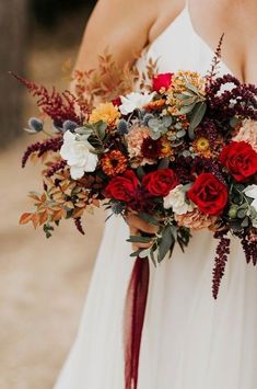 a woman holding a bouquet of flowers in her hands