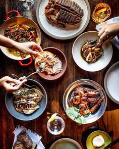 several plates of food on a wooden table