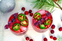 two glasses filled with red and green drinks