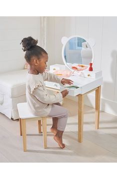 This dressing table and stool, perfect for any little boy or girl, has five drawers offering plenty of storage for little treasures. A generous large round mirror is inspired by forest friends. Ages 3 and up 23.62" x 16.14" x 37.8" table; 13.39" x 9.8" x 13.31" chair 30.91 lb. Rubber wood Spot clean Imported Toddler Room Tables, Kids Dresser Pottery Barn Kids, Kids Table And Chairs In Bedroom, Vanity Table For Kids, Childrens Makeup Vanity, Children Room Furniture, Forest Furniture, Large Round Mirror, Playroom Furniture