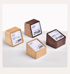 three wooden boxes with numbers on them and one has a price tag attached to it