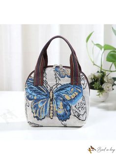 BirdinBag - Embroidered Butterfly Canvas Handbag with Phone Pouch - Stylish and Practical Blue Large Capacity Pouch For Daily Use, Blue Spacious Pouch For Daily Use, Portable Tote Pouch For Daily Use, Embroidered Beige Shoulder Bag For School, Beige Embroidered Shoulder Bag For School, Embroidered Satchel Shoulder Bag For School, Travel Embroidered Beige Shoulder Bag, Embroidered Beige Shoulder Bag For Travel, Blue Embroidered Bag For Daily Use