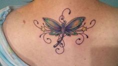 a woman with a butterfly tattoo on her back