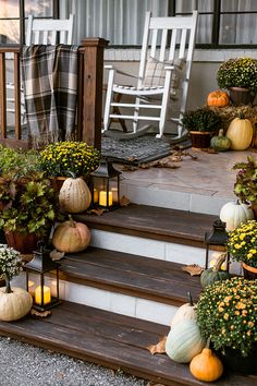 pumpkins and gourds are on the front steps