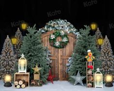 christmas decorations and lights are displayed in front of a wooden door, surrounded by trees