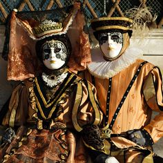 two masked people sitting next to each other