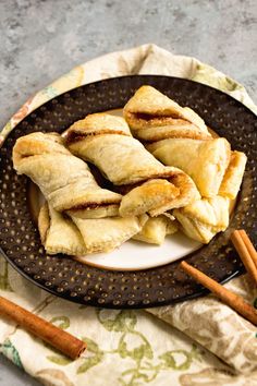 cinnamon sugar pastries on a plate with cinnamon sticks