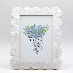 a white frame with blue flowers in it