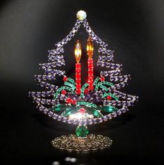 a lighted christmas tree ornament with red, green and blue beads on it