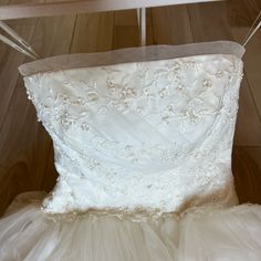 a white wedding dress hanging on a hanger