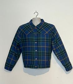 A beautiful vintage wool western style jacket, made by Levi's in the mid 90s and finished in a bright bold check!  Condition is excellent and appears to have been very sparingly worn! There is no damage and no evidence of marks, the quilted lining is perfect and guaranteed to keep you warm!  There is no sizing listed but please check measurements, it buttons right over left but I feel it would look great on either a man or woman and could be worn oversized on a smaller frame :) Measurements are: Western Style Blue Winter Outerwear, Rockabilly Long Sleeve Outerwear For Fall, Retro Long Sleeve Outerwear For Rodeo, Fitted Blue Western Outerwear, Fitted Long Sleeve Rockabilly Outerwear, Vintage Levi's Blue Outerwear, Vintage Long Sleeve Plaid Outerwear, Retro Plaid Button-up Outerwear, Retro Wool Plaid Outerwear