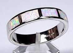 "(Guaranteed 100% Sterling Silver) Brand new spectacular high quality silver Eternity band style ring with white inlay Fire Opal stones set on solid 925 sterling silver and stamped with 925. This ring has 10 total pieces of opal inlay stones all across the band. The width of the ring measures 6mm (1/4\"). Our silver is genuine 925 sterling silver and Rhodium plated for better quality and prolonged shine. You will receive the item in a gift box. Thanks for looking and buy with confidence. Please Silver Opal Ring With Inlay For Anniversary, Anniversary Silver Opal Ring With Inlay, Sterling Silver White Inlay Ring, White Sterling Silver Ring With Inlay, White Sterling Silver Rings With Inlay, Gold Finger Rings, Silver Jewelry Cleaner, Opal Band, Tungsten Wedding Bands