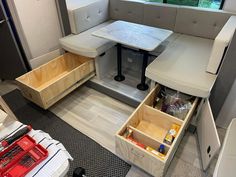 the inside of a camper with drawers and table in it's center area