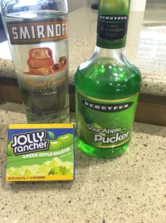 a bottle of soap next to an empty glass and box of san antonio's green apple cider