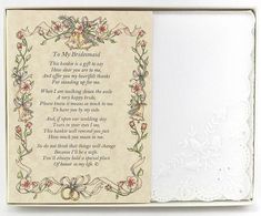 an open box with a poem in it on top of a white table cloth and doily