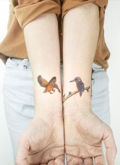 two people with matching tattoos on their arms