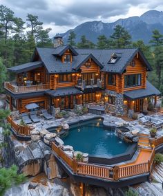 an aerial view of a large log home with a pool and hot tub in the foreground