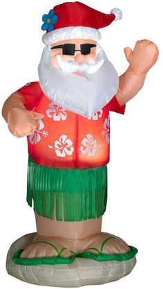 an inflatable statue of a man wearing a red shirt and green grass skirt