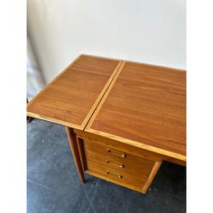 a wooden desk with two drawers on it