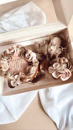 a cake in a box with flowers on it