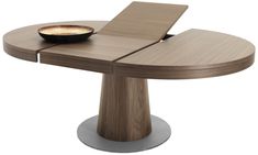 a wooden table with a laptop on it and a bowl of food in the middle