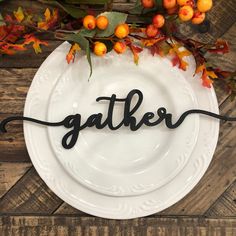 a white plate with the word gather written in cursive black ink on it