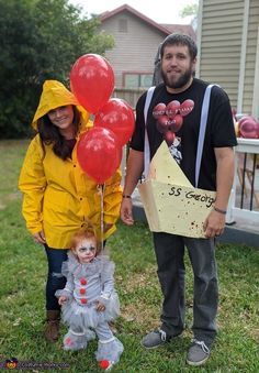 a man and woman standing next to each other in front of a house with balloons