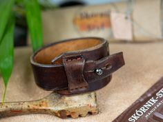 Genuine leather bracelet decorated with Baltic amber for a unique woman. This unique bracelet was made entirely by hand from a single piece of thick cowhide. dimensions: - thickness 4-5 mm - width at the widest point 3.8 cm - max inner circumference of the fastened bracelet 18.5 cm - fits wrist up to 17 cm in circumference This unique bracelet will be the best gift for your beloved woman. Vintage Leather Bracelet Wristband, Vintage Leather Wristband Bracelet, Adjustable Leather Bracelet With Strap, Leather Bangle Bracelet, Adjustable Leather Bracelet With Wrist Strap, Vintage Brown Cuff Bracelet With Wrist Strap, Vintage Leather Cuff Bracelet With Wrist Strap, Adjustable Leather Cuff Bracelet With Bracelet Strap, Adjustable Leather Wristband With Waxed Finish