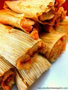 three tamales stacked on top of each other with meat and cheese in the middle