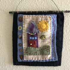 a quilt hanging on a wall with buttons