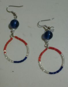 two pairs of red, white and blue beaded hoop earrings with beads on them