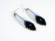 Feather Earrings are 3" long including the ear wire. The great thing about beadwork earrings is they are very light weight, even when 3".  The smooth leather backing is sewn by hand to the beadwork. Available and in stock.  3 INCH LONG FEATHER EARRINGS. Note - these are the tiniest beads, (which are the hardest to create with, of course.)  The Feather Earrings and the Cuff are Sold Separately.  You may purchase the Cuff Bracelet OR the Feather Earrings OR Both.  Feather Earrings are 3" long incl Beaded Feather Earrings, American Quilts Patterns, Beaded Feather, Native Earrings, Beaded Patterns, Native American Beadwork Patterns, Native Beading, Twin Beads, Beadwork Earrings