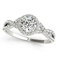 a white gold ring with an oval diamond center surrounded by pave set round brilliant cut diamonds