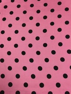 a pink and black polka dot fabric with small black dots on the back of it