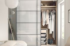 an open closet with clothes and other items