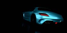 a blue sports car in the dark with its hood up and tail lights turned on