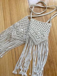 Intricately, handcrafted, made with love and attention to detail, these macrame cross body bags are a must accessory to add a little life to your outfit. With stylish tassel accents, they make a wonderful gifts for the everyday women to elevate their style. Linen lining inside with pockets to store your mobile and a zipped pocket for the little secure items you wish to store. Two options available, both are the same pattern on front and back and both are the same on the inside. The one pictured left is a slightly shorter and darker version with a little love heart zipper. The one pictured right is longer and has a standard zipper. Please see last photo for dimensions and make sure to select either A or B at checkout. It is made from durable cotton rope and is 100% handmade by high quality Bohemian Crochet Bag With Macrame For Vacation, White Bohemian Crochet Bag With Adjustable Strap, Macrame Crossbody Bag For Beach, Bohemian Crochet Bag With Tassels For Everyday Use, Bohemian Crochet Bag With Fringe For Festivals, Bohemian Crochet Bag With Tassels In Natural Color, Bohemian Crochet Bag With Tassels, Bohemian Macrame Shoulder Bag For Vacation, Bohemian Macrame Shoulder Bag For Summer