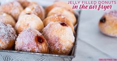 jelly filled donuts in the air fryer with powdered sugar on top and cranberry filling