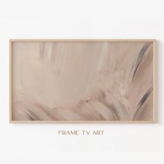 the frame tv art is hanging on the wall above it's white and beige paint