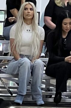 lady with long white hair sitting in the stands