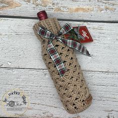 a bottle wrapped in burlock and tied with a ribbon