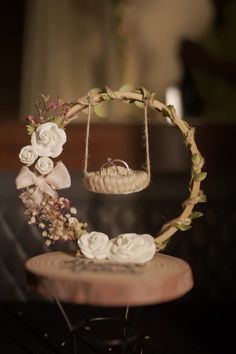 a cake with flowers on top of it and a basket hanging from the ceiling in front of it