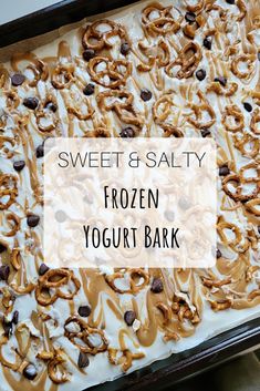 a frozen yogurt bark with chocolate chips and pretzels on top in a baking pan